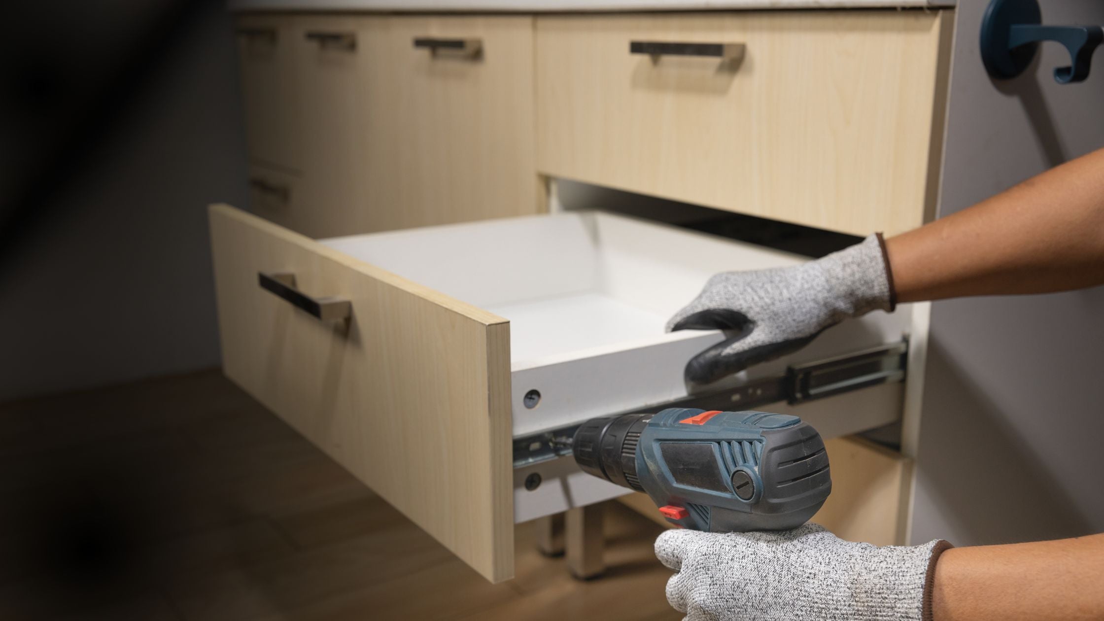 Full extension undermount drawer slides installed beneath a drawer box in a cabinet