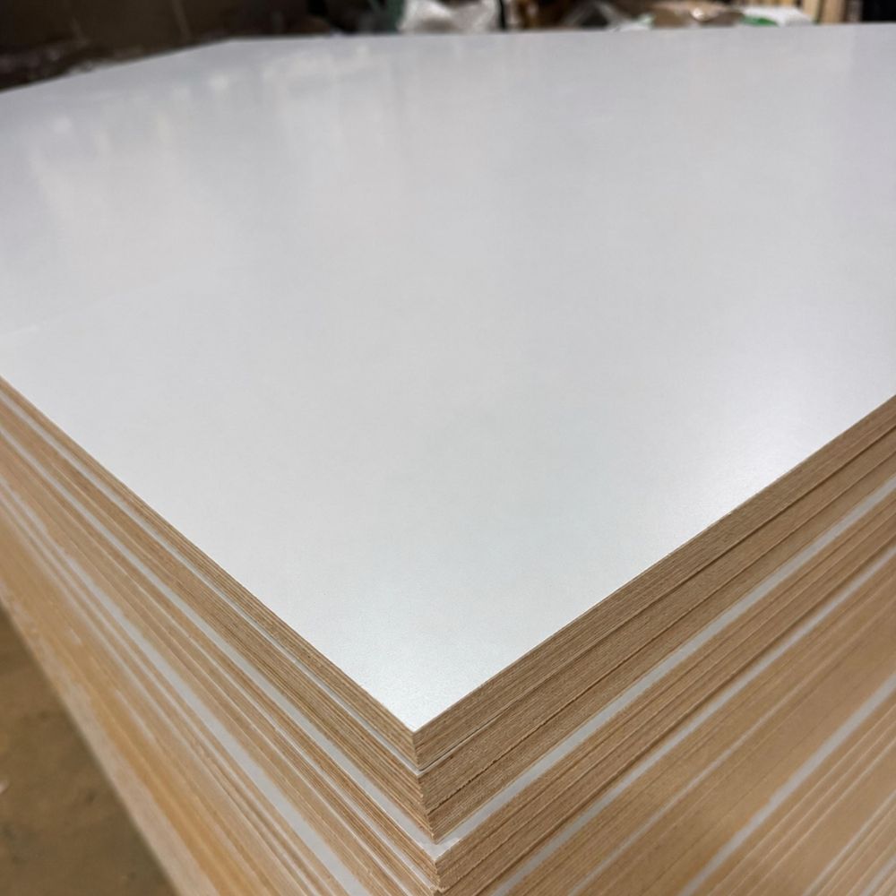Close-up of light gray prefinished plywood with a multi-ply poplar core.
