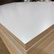 Close-up of light gray prefinished plywood with a multi-ply poplar core.